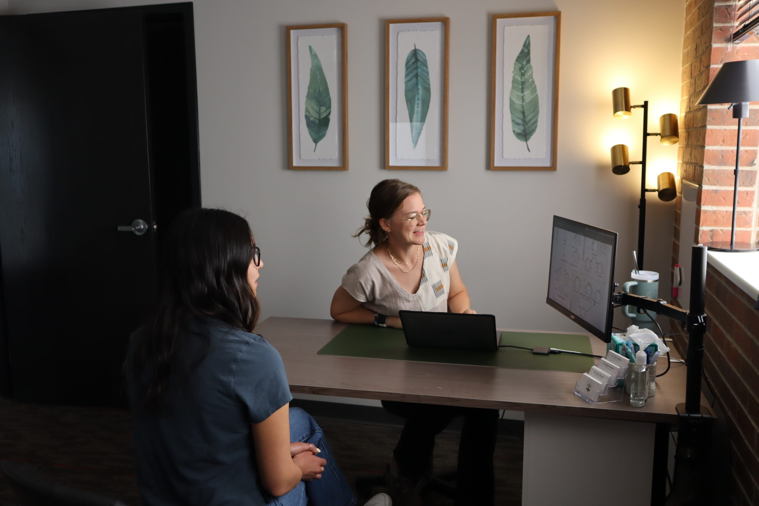 IMG_4563 Dr. Danica Woods going over lab results with a patient on an external monitor